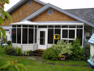White combined-style conservatory with dark windows