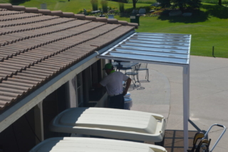 An alternate view of a small patio cover used to shade a lunch counter at a golf course