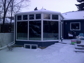 Exterior View of a white and blue conservatory during winter
