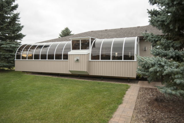 Exterior view of large sunroom with fireplace