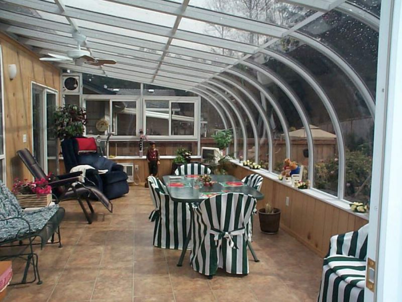 Decorated interior view of a large white sunroom