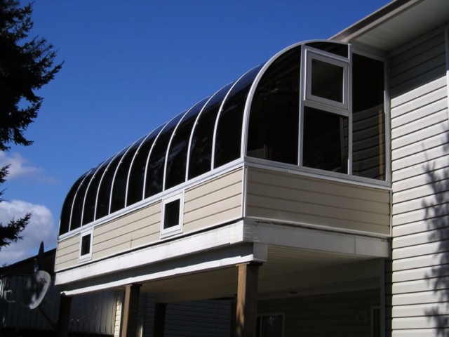 Exterior view of a sunroom attached to the second storey of a house