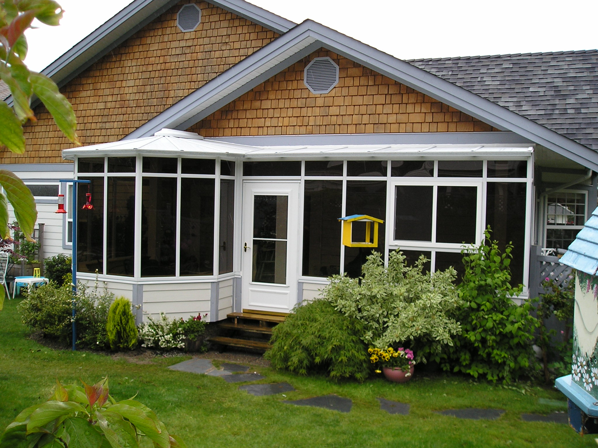 A combined sunroom and conservatory on the back of a house