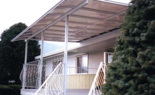 White curved end patio cover over a deck with white railings
