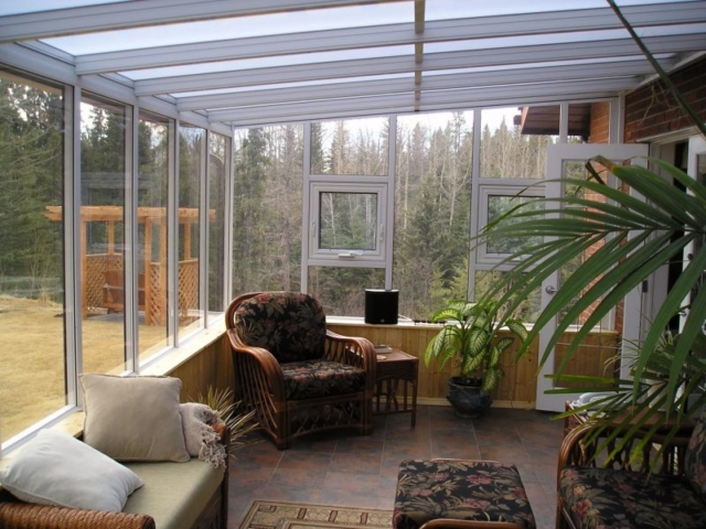 Decorated interior view of a white straight eave sunroom