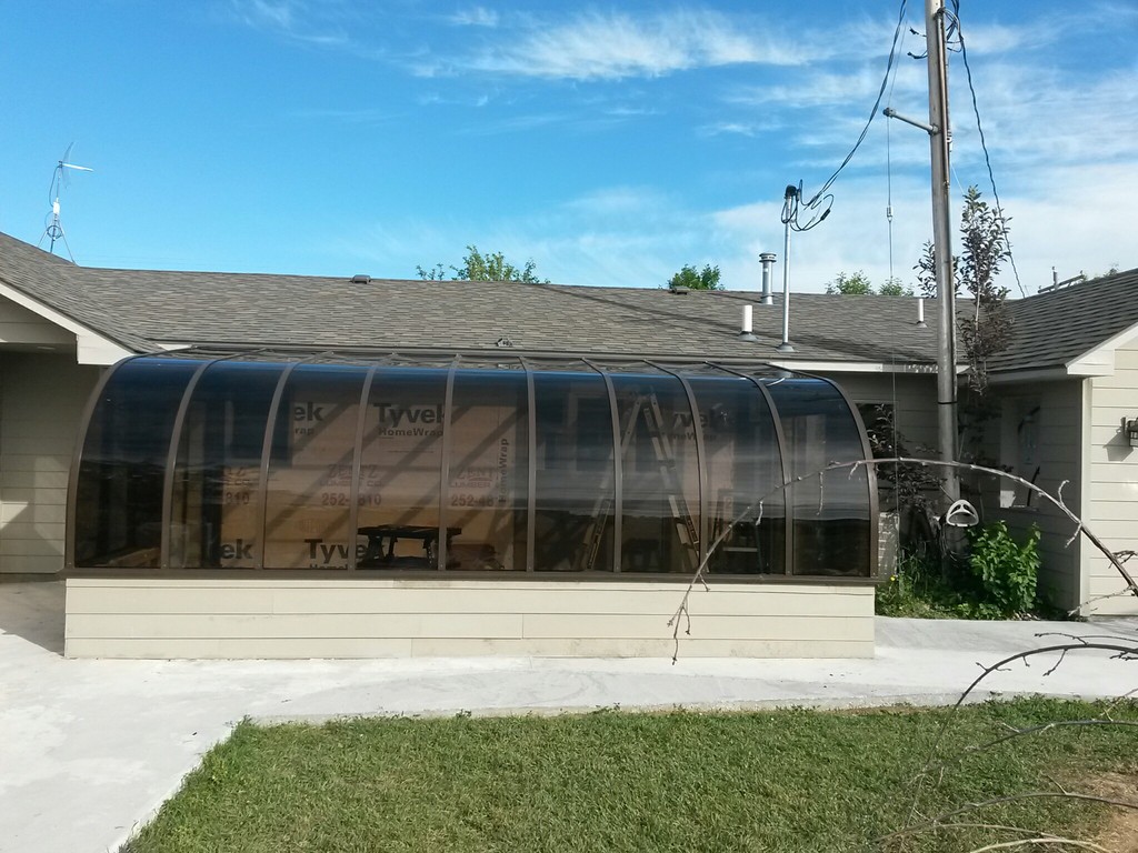 Exterior of house with brown curved sunroom Montana